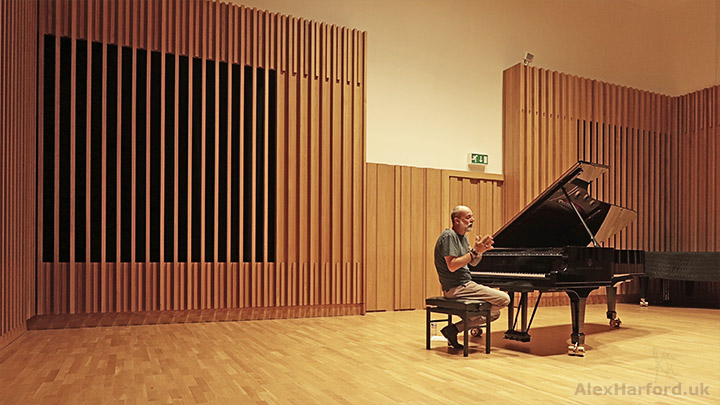 Fabrizio Paterlini sits by the piano while talking to the audience (not pictured).